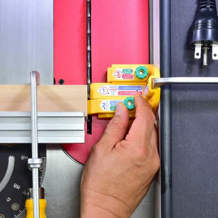 Hand using dado setup gauge tool on a table saw for precise woodworking cuts