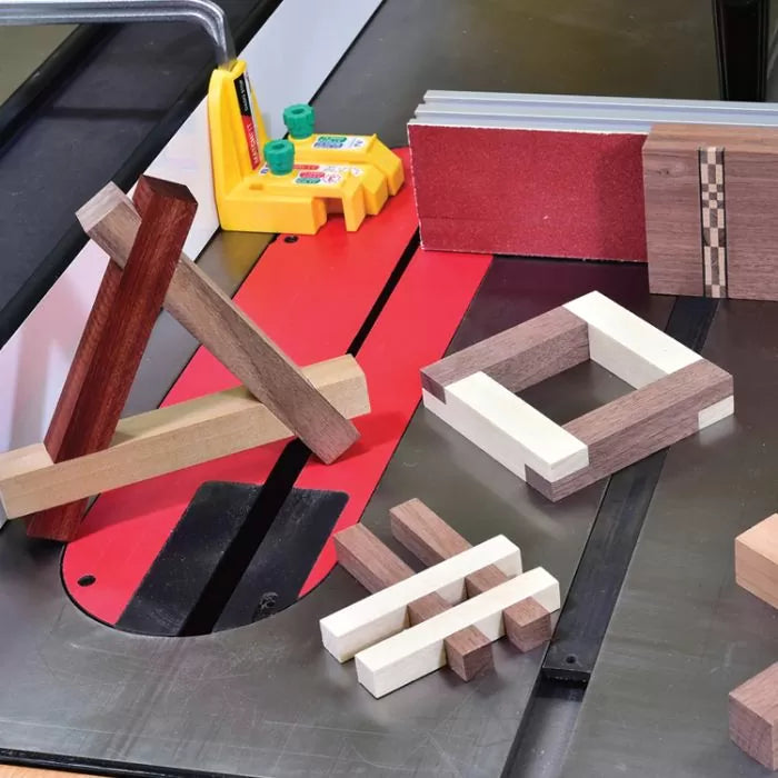 Wood joinery samples on a table saw with sanding block and push block, woodworking tools