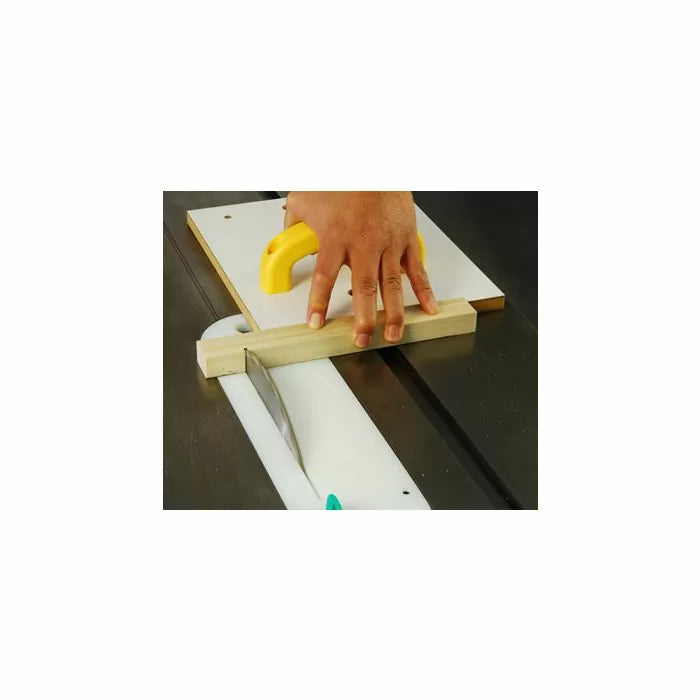 Woodworker using a table saw sled to cut wood with push handle for safety