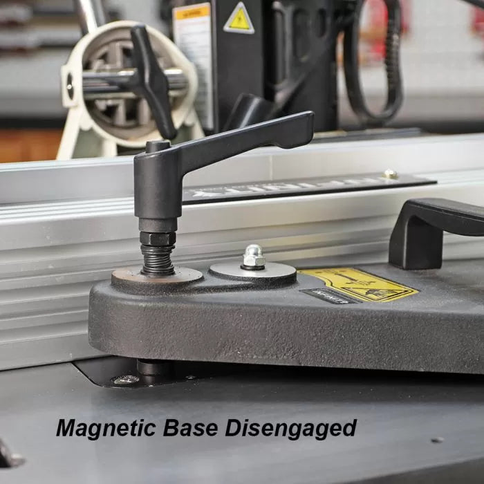 Close-up of a woodworking tool with magnetic base disengaged, lever handle shown on table saw.