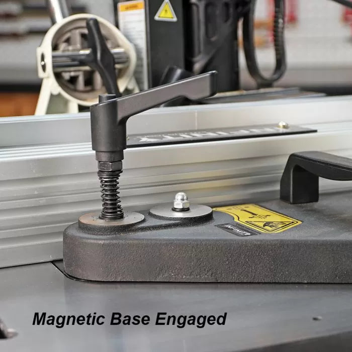 Magnetic base hold-down clamp engaged on woodworking table for precision tool setup