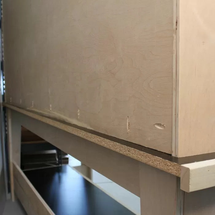 Close-up of woodworking joinery using pocket holes on a plywood workbench frame