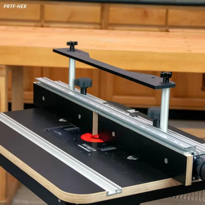 Woodworking router table fence system with micro-adjust knobs and clear scale in workshop