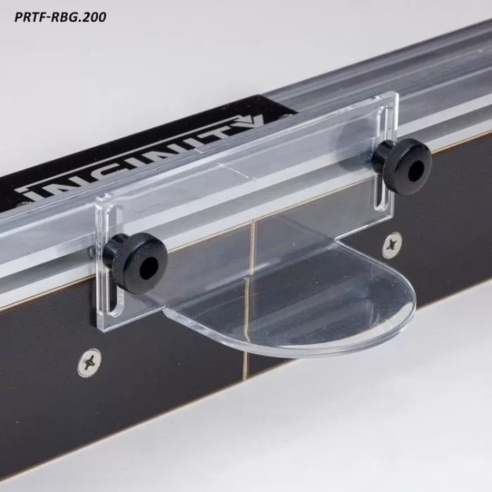 Clear router table safety shield with adjustment knobs mounted on a black fence.