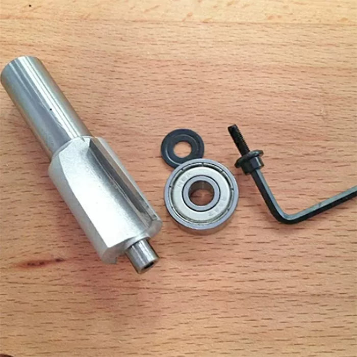 Router bit bearing kit with adapter, bearing, washer, screw, and hex key on wood surface