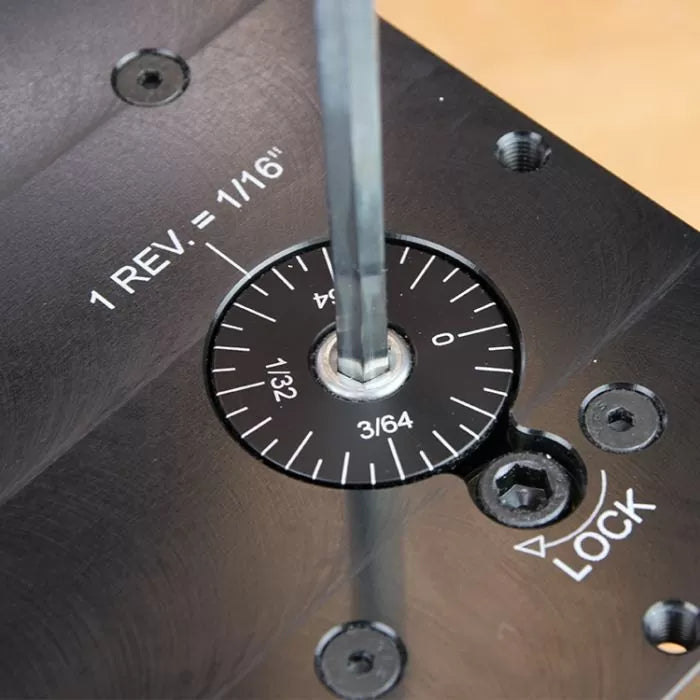 Close-up of router table micro-adjustment dial with hex key, precision woodworking tool