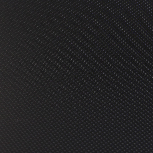 Close-up of black microdot laminate sheet with textured surface for woodworking projects