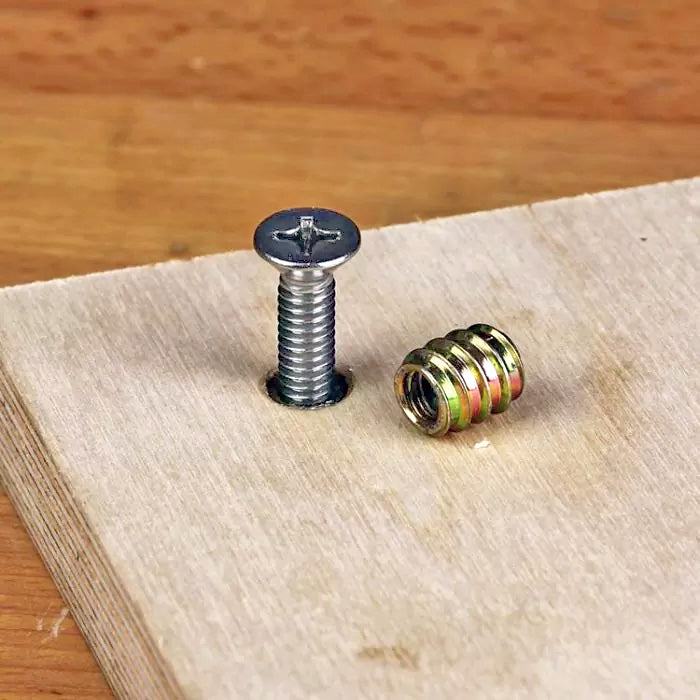 Threaded insert and Phillips head screw on plywood board for woodworking projects