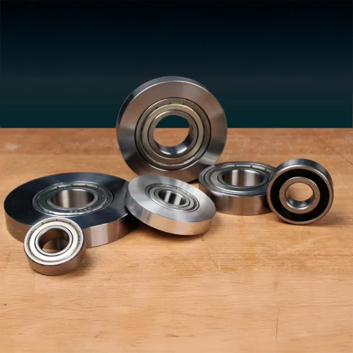 Assorted steel ball bearings for woodworking tools on a wooden surface