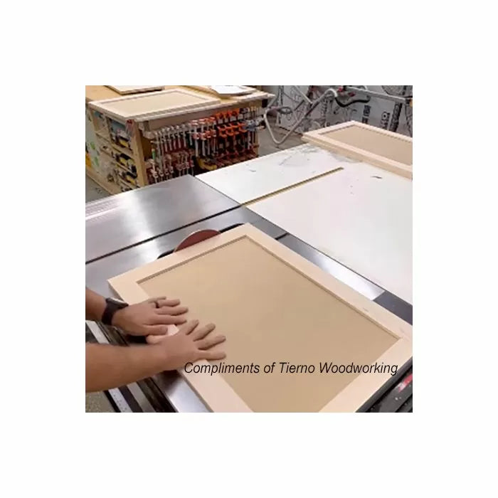 Woodworker assembling shaker-style cabinet door on a workbench in a woodworking shop