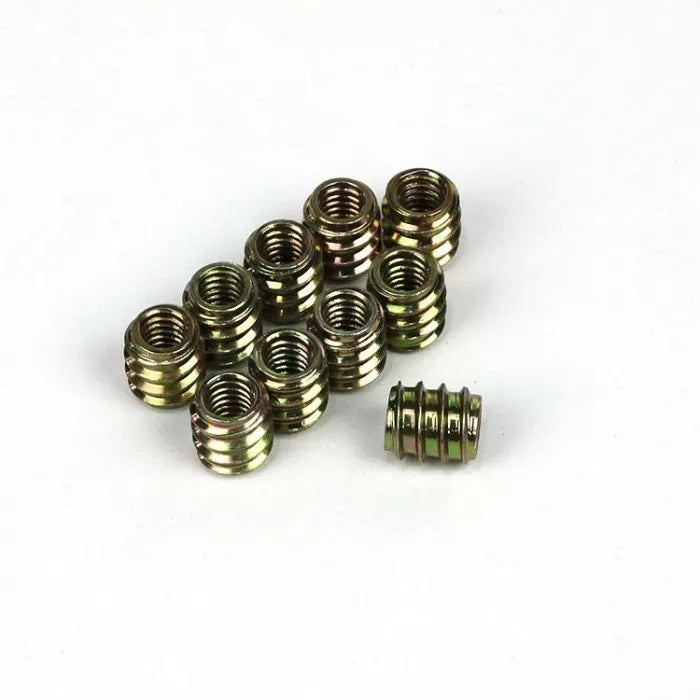 Brass threaded inserts for woodworking on a white background