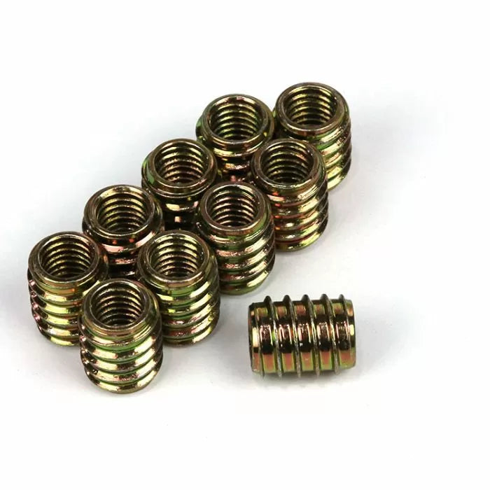 Brass threaded wood inserts for woodworking projects on white background