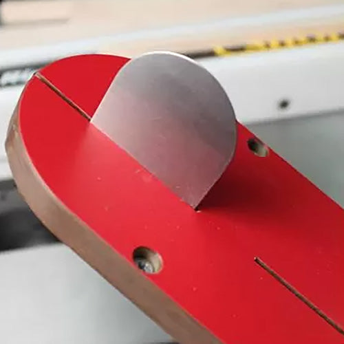 Table saw blade alignment tool on a red insert plate for woodworking precision