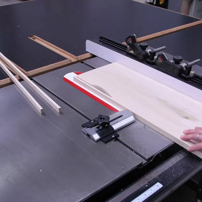 Table saw cutting wooden board with miter gauge and strips for precise woodworking