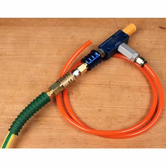 Woodworking air hose kit with connectors, fittings, and orange tubing on workbench