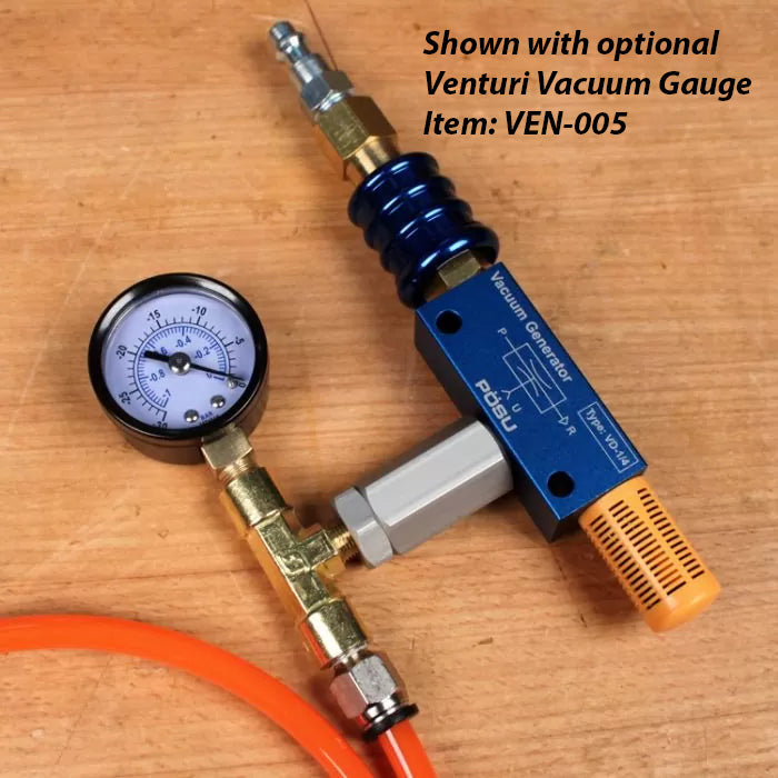 Vacuum generator with gauge, blue and orange fittings, on a woodworking bench