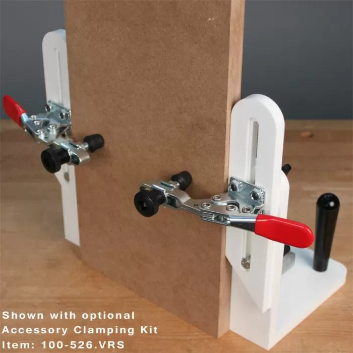Woodworking clamping jig kit securing a wooden board for precise cutting or assembly