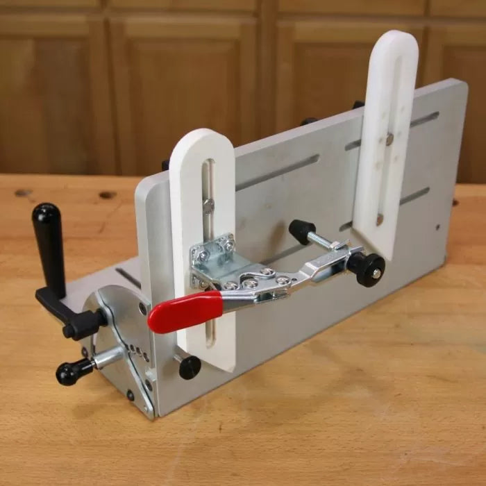 Woodworking router table jig with adjustable clamps on a workbench