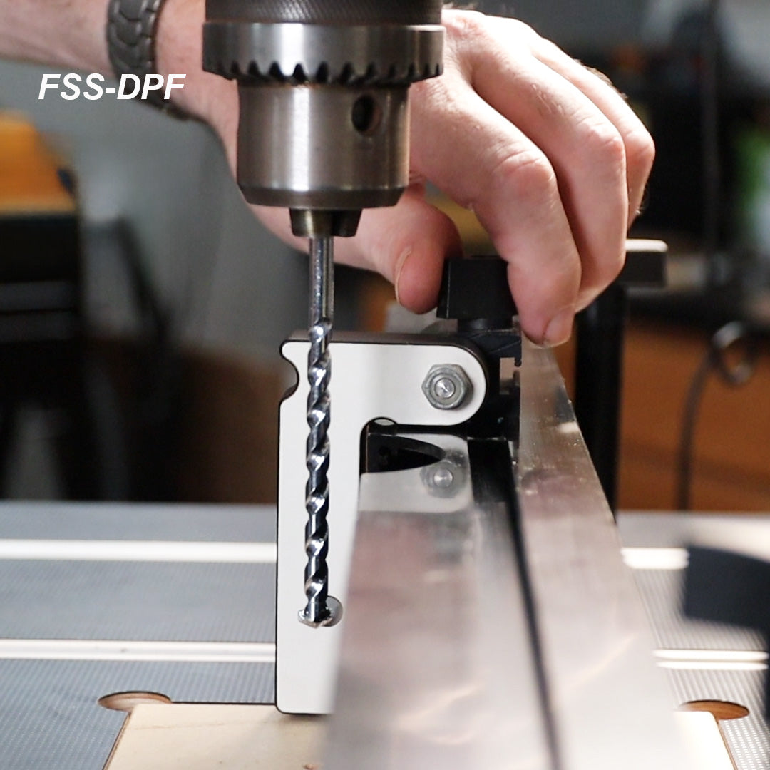Drill press fence stop attachment with drill bit on a woodworking table