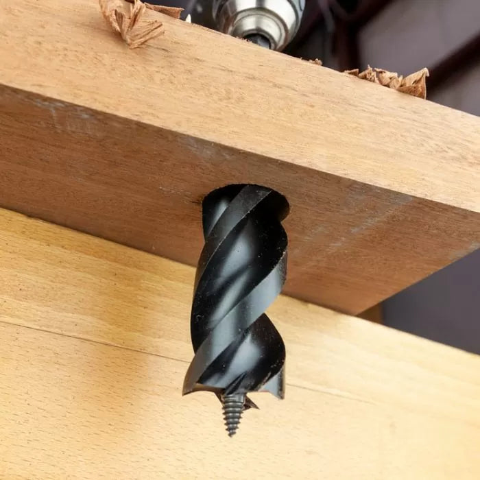 Large wood auger drill bit boring clean hole through hardwood board