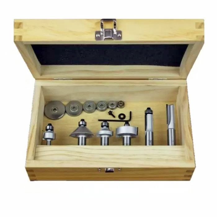 Woodworking router bit set in open wooden case with multiple bits and accessories