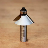 Chamfer router bit with bearing on wooden surface, woodworking tool for clean angled edges