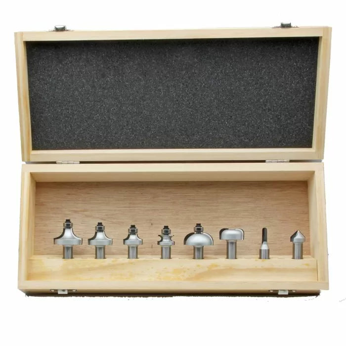 Woodworking router bit set in wooden case with foam padding, assorted bit shapes visible