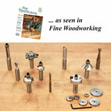 Assorted woodworking router bits, bearings, and wrench displayed on a wooden table.