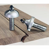 Roundover router bits with bearings on wood, showing smooth rounded edge profiles.