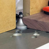 Woodworking router table with roundover router bit shaping the edge of a wood board