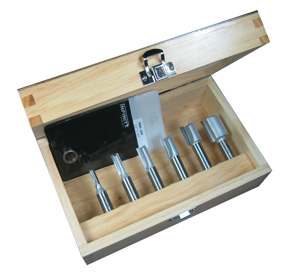 Wood router bit set in open wooden case with five straight router bits displayed