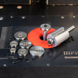 Router bit with multiple ball bearing guides and hex key on a router table top