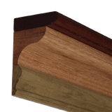 Close-up of a wooden crown molding joint with detailed routed edge profile.