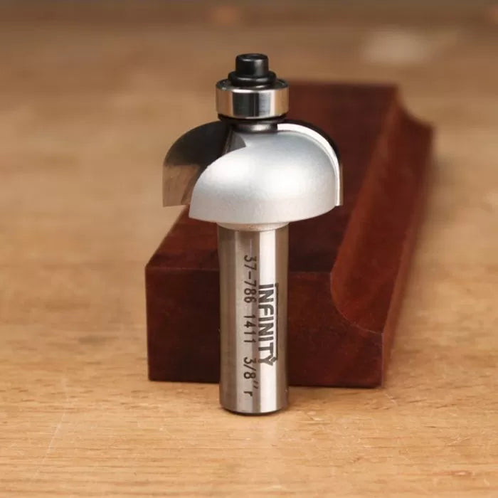 Round nose router bit with bearing, used for woodworking, shown on a wood surface.