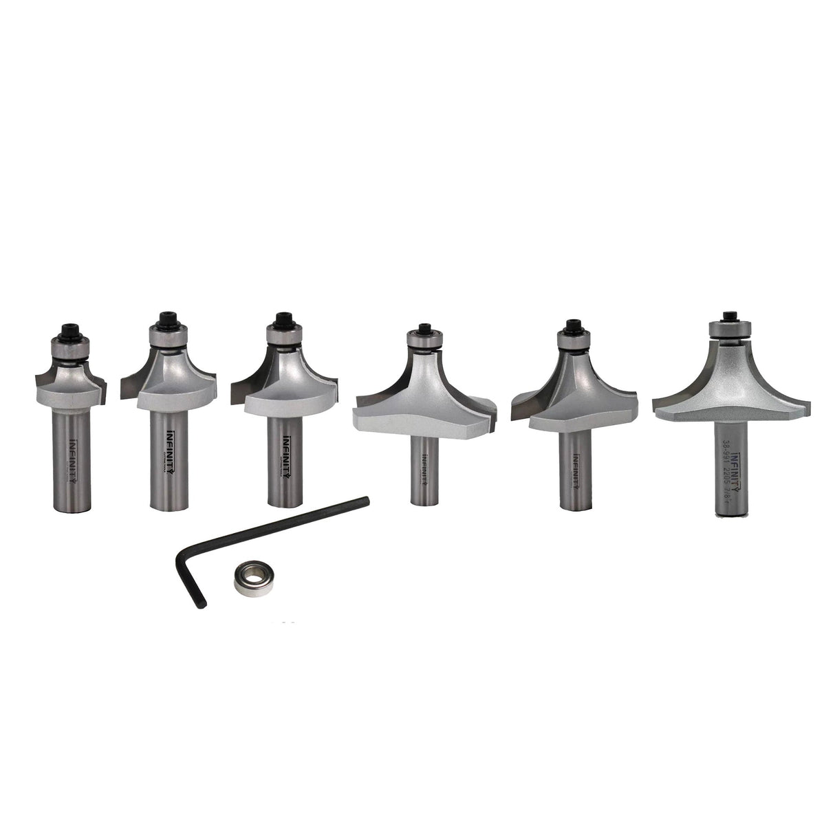 Set of six round over router bits with hex key and bearing on white background