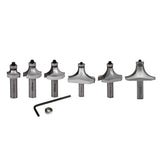 Set of six round over router bits with hex key and bearing on white background