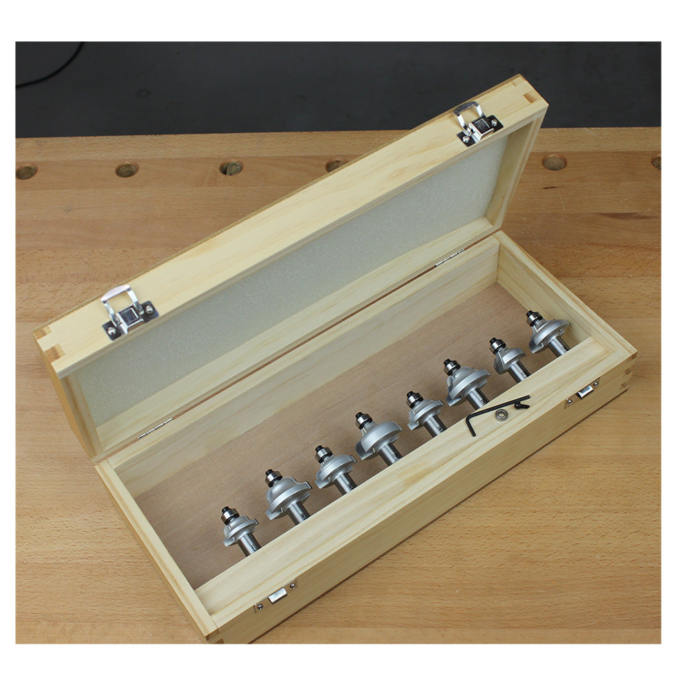 Woodworking router bit set in a wooden case on a workbench