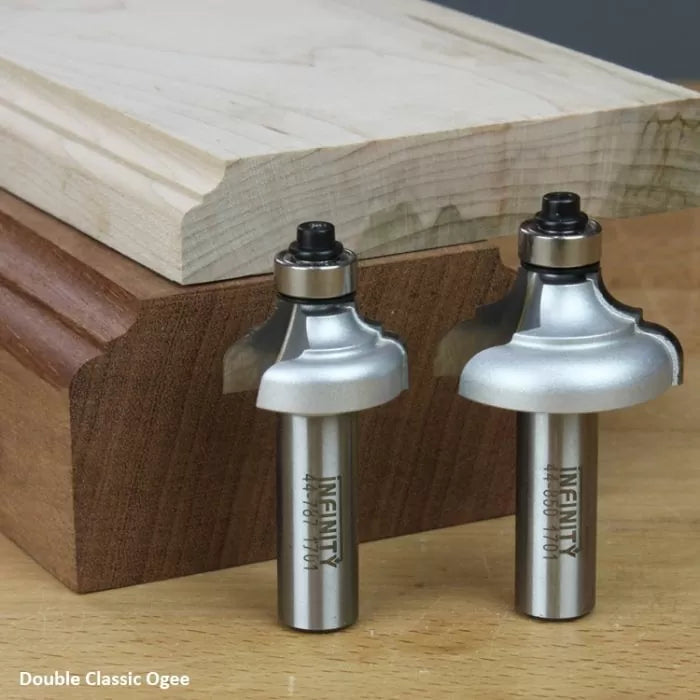 Double classic ogee router bits with decorative wood molding sample on a workbench.