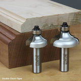 Double classic ogee router bits with decorative wood molding sample on a workbench.