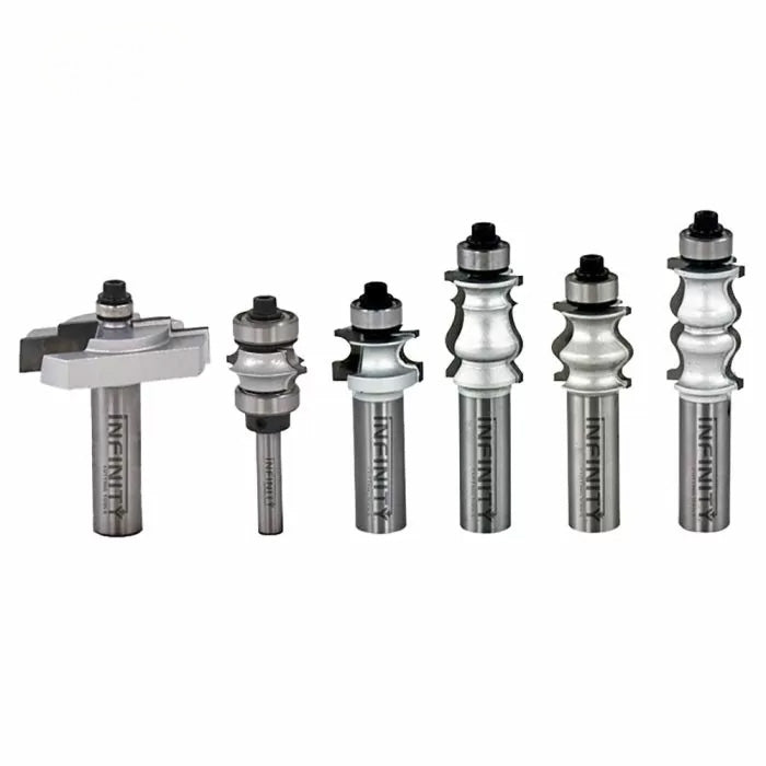 Set of six carbide woodworking router bits with ball bearing guides on white background