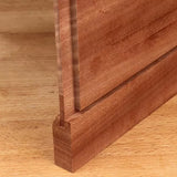 Close-up of a tongue and groove wood joint on a wooden workbench, ideal for woodworking projects.