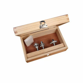 Wooden case with three router bits for woodworking and an accessory block