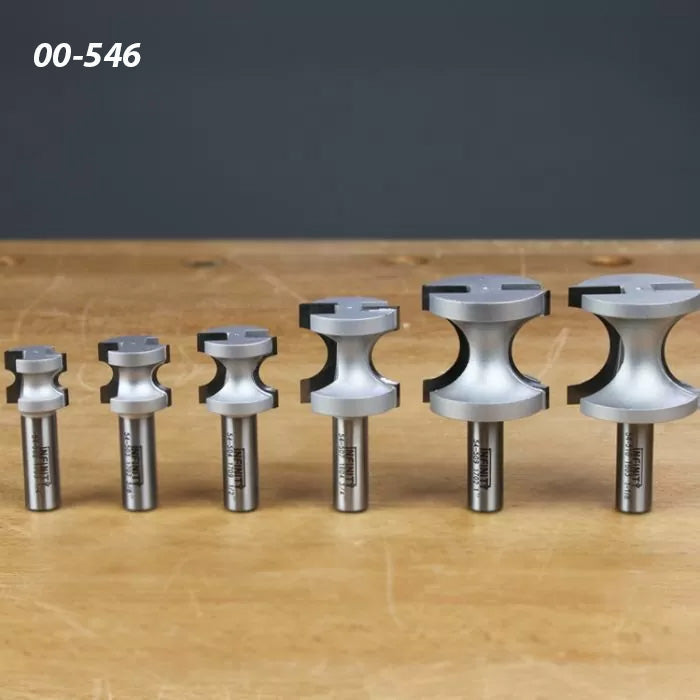 Set of six woodworking router bits with varying sizes on wooden tabletop