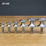 Set of six woodworking router bits with varying sizes on wooden tabletop