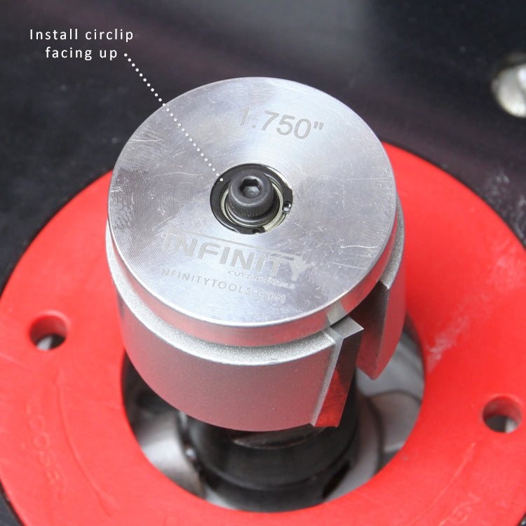 Close-up of a router lift insert with a 1.750 inch diameter spindle and circlip installation guidance.