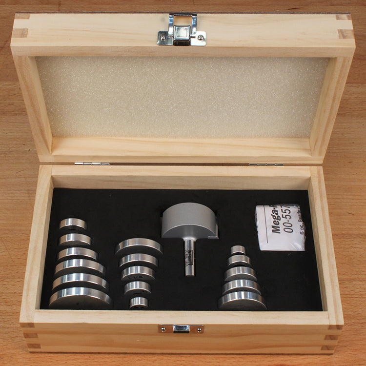 Woodworking router bit set with multiple bearings in a wooden storage case on a workbench