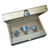Wooden box with three metal router bit jigs for woodworking tool setup