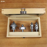 Woodworking router bit set in wooden case on workbench, decorative edge profiles visible