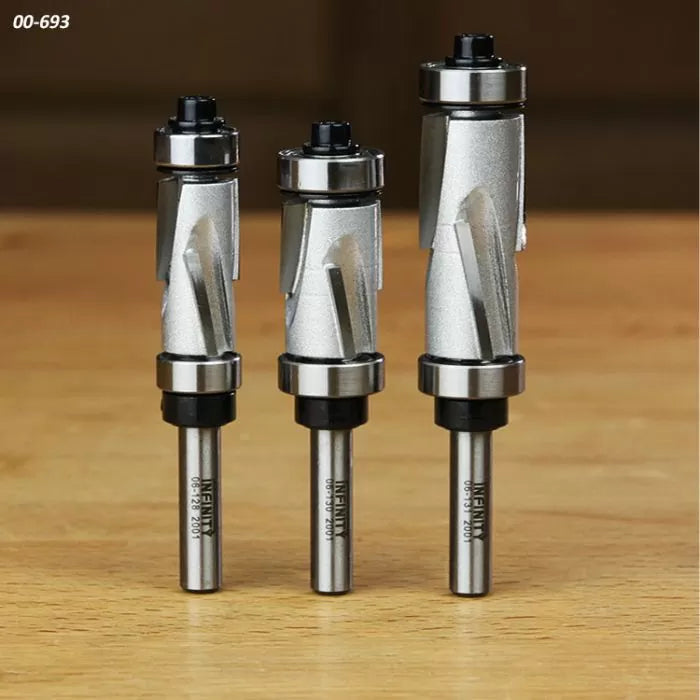 Set of three carbide spiral flush trim router bits on wooden surface