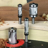Carbide spiral router bits for woodworking displayed with wood shavings on a workbench.